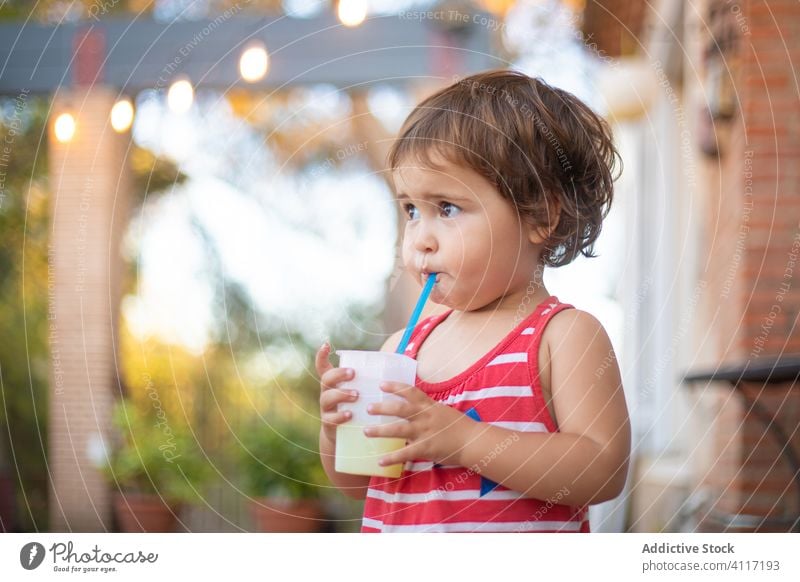 Adorable toddler drinking fresh juice from a straw summer rest stand child kid beverage relax adorable cute water vacation little joy childhood pleasure cool
