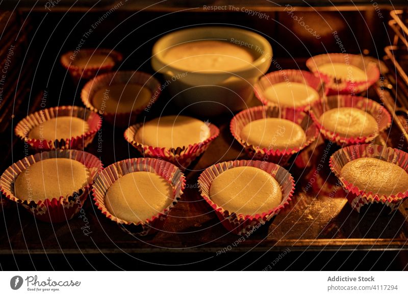 Home made cupcakes in oven bake home kitchen pastry open hot food tray muffin dessert stove dish meal prepare appliance sweet snack fresh lifestyle homemade