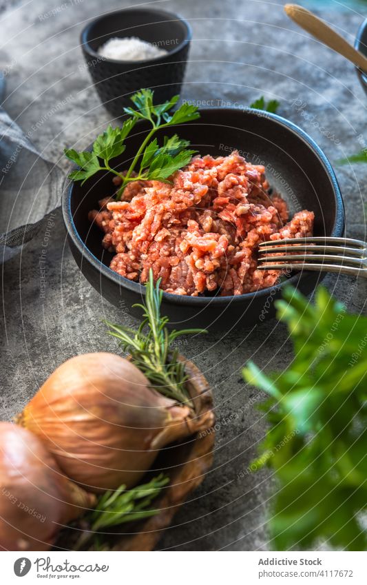 Herbs and onions near minced meat herb table kitchen rustic salt fresh food cuisine ingredient gourmet nutrition lunch dinner homemade seasoning protein