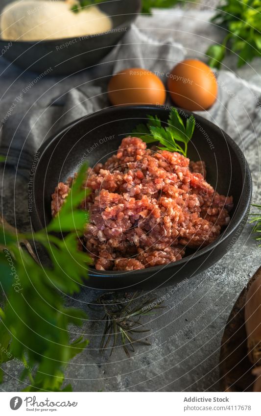 Bowl of minced meat near eggs and herbs kitchen cook ingredient fresh rustic meal food gourmet nutrition lunch organic recipe homemade cuisine table culinary