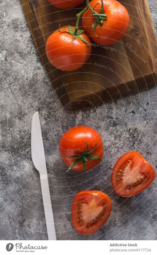 Ripe tomatoes on gray table kitchen fresh cook ingredient half whole food organic healthy vegetable cuisine ripe natural vegetarian nutrition diet recipe