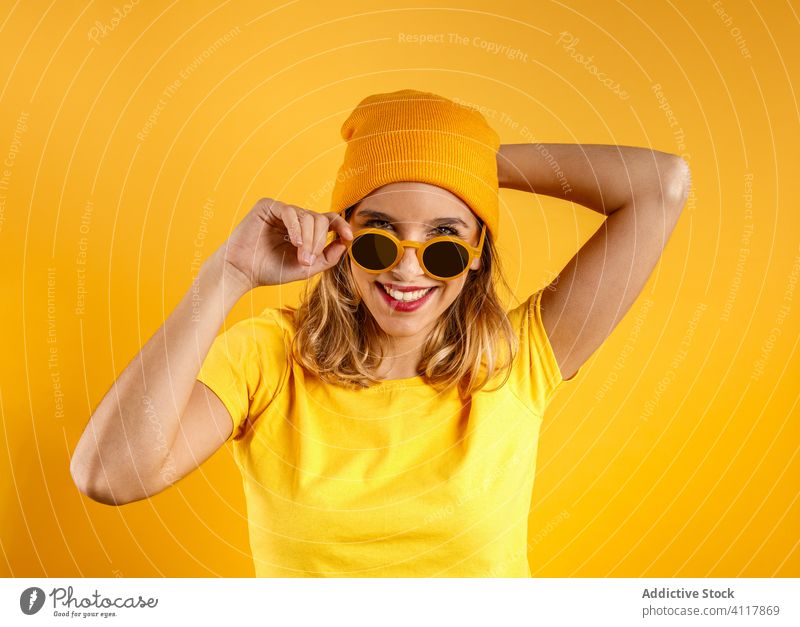 Positive female on colorful background woman modern positive sunglasses style bright trendy fashion cheerful accessory happy hipster vibrant smile vivid