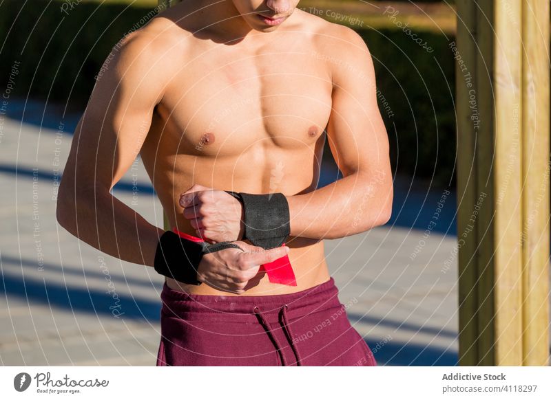 Shirtless ethnic sportsman without t shirt on street training city shirtless examine sunny daytime fitness male workout healthy muscular strong athlete wellness
