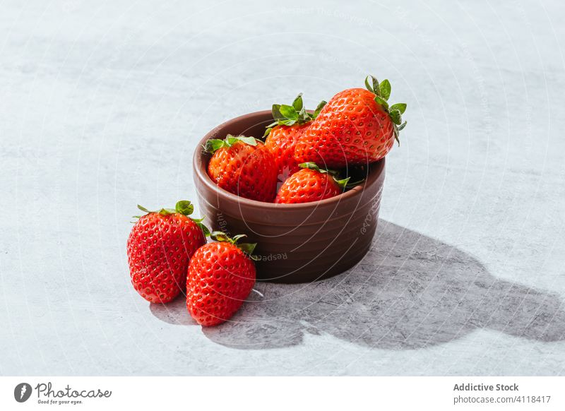 Fresh strawberries on light table strawberry ripe fresh red bowl natural healthy food delicious sweet vitamin summer fruit dessert season diet ingredient tasty