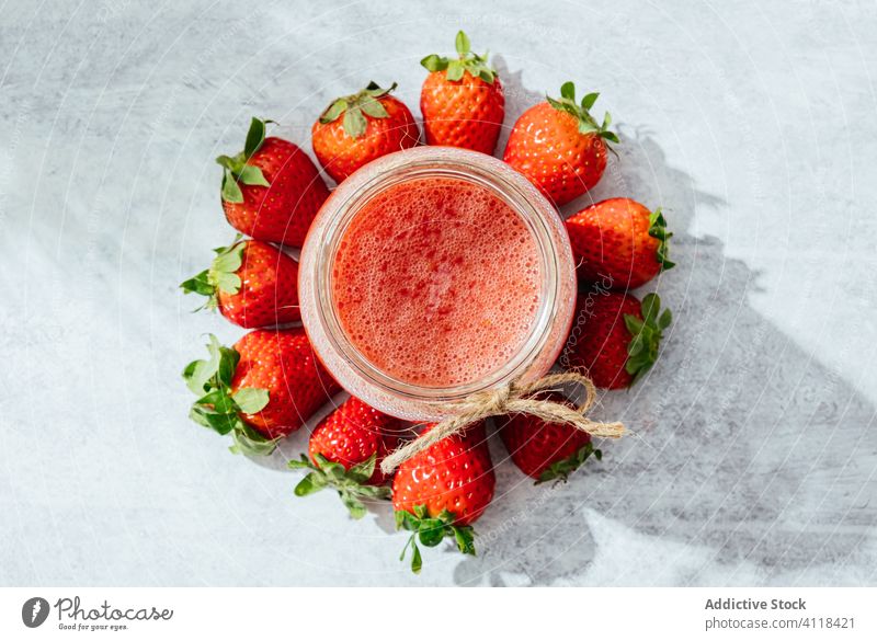 Healthy strawberry drink in glass jar juice homemade rustic fresh natural healthy twine tasty ripe delicious food vitamin ingredient nutrition appetizing table