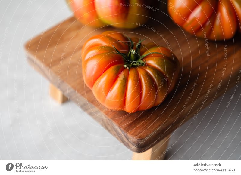 Composition with red tomatoes on table fresh ripe natural raw wooden board food vegetable cook whole appetizing kitchen healthy meal vegetarian eat diet harvest