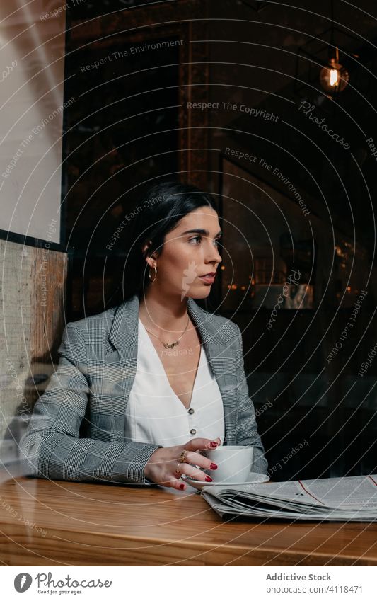 close-up of a woman behind a window female businesswoman cafe bar table lifestyle work coffee sitting girl restaurant book caucasian brunette people person cup