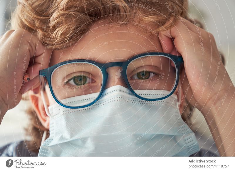 Boy in medical mask and glasses boy quarantine smart home coronavirus pandemic prevent kid child disease protect health care safety accessory respiratory