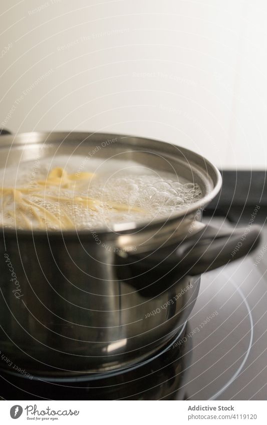 Saucepan with boiling water and spaghetti pasta prepare saucepan noodle homemade kitchen cook food kitchenware metal appliance steam domestic stainless modern