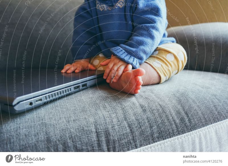Close up of a baby using a laptop close up technology port usb hdmi keyboard hands touch touching pc computer home living room life lifestyle future progress