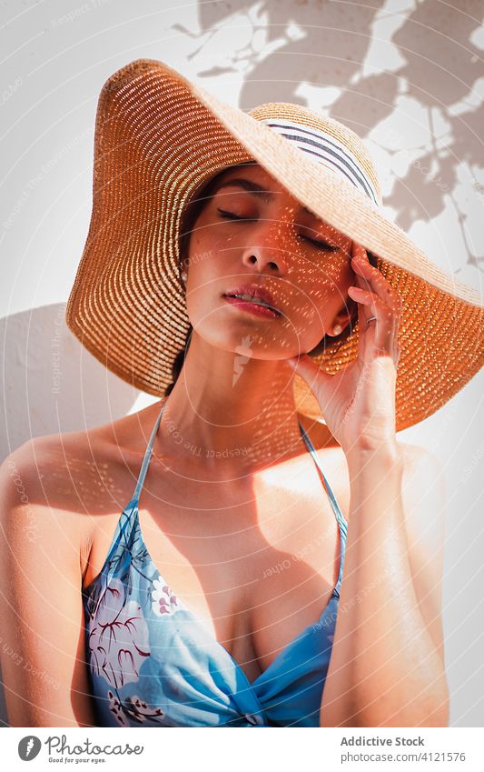 Relaxed woman enjoying sunny day summer rest relax hat street style young tranquil vacation carefree female lady holiday travel tourism calm sundress harmony
