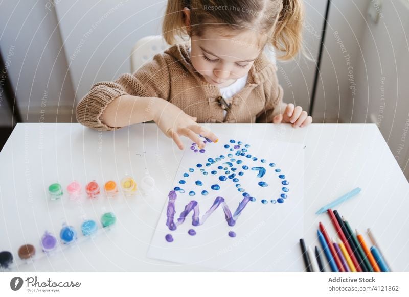 Little girl using gouache for drawing with fingers on paper at home child paint kindergarten creative kid cute education pencil learn elementary little adorable