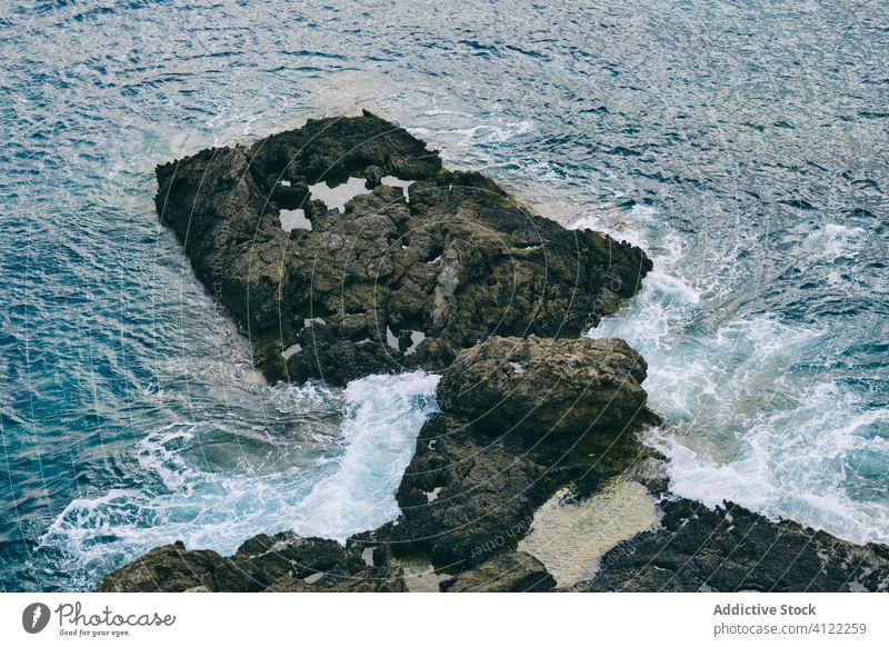 Ocean seashore with waves dashing against rocky cliffs water storm power crash splash motion ibiza spain ocean overcast coast stone seascape environment weather