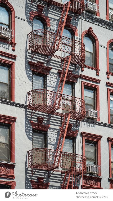 Exterior of residential building with fire escapes architecture exterior stair balcony wall facade city classic old typical apartment street new york nyc usa