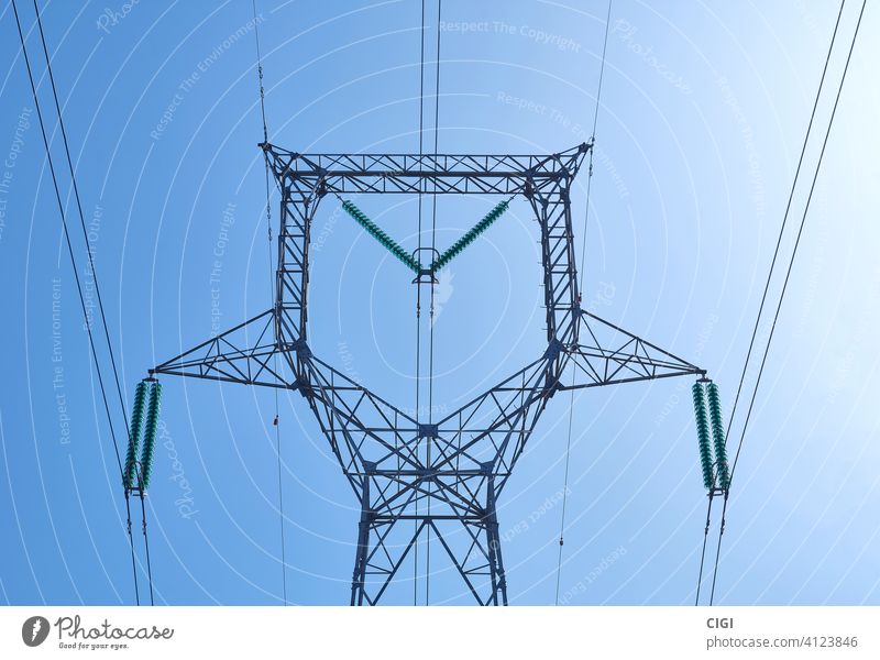 High voltage electrical power distribution turret over clear sky tower energy electricity high wire cable line supply industrial metal transmission engineering