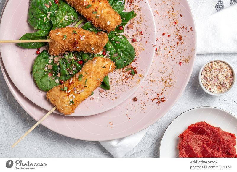 Battered chicken skewers in fried panko on restaurant table breaded food crispy snack meal golden appetizer dinner crunchy gourmet coated delicious cooked hot