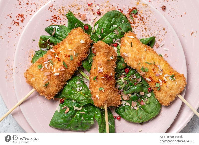 Battered chicken skewers in fried panko on restaurant table breaded food crispy snack meal golden appetizer dinner crunchy gourmet coated delicious cooked hot