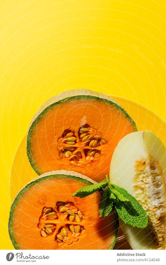 Fresh assortment melon with mint  on yellow fruit summer fresh diet food healthy sweet cold green background ripe vitamin freshness nutrition Japanese melon