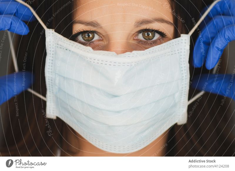 Woman in protective mask and gloves working at home woman coronavirus covid safety pandemic risk disease female serious outbreak put on infection prevent care