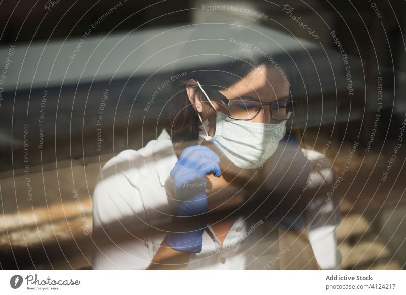 Woman in protective mask and gloves working at home woman coronavirus covid safety pandemic risk window disease female serious outbreak put on infection prevent
