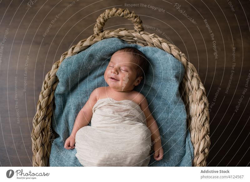 Infant sleeping on blanket in basket baby home wicker peaceful newborn lying soft floor innocent infant child kid dream adorable serene little tranquil