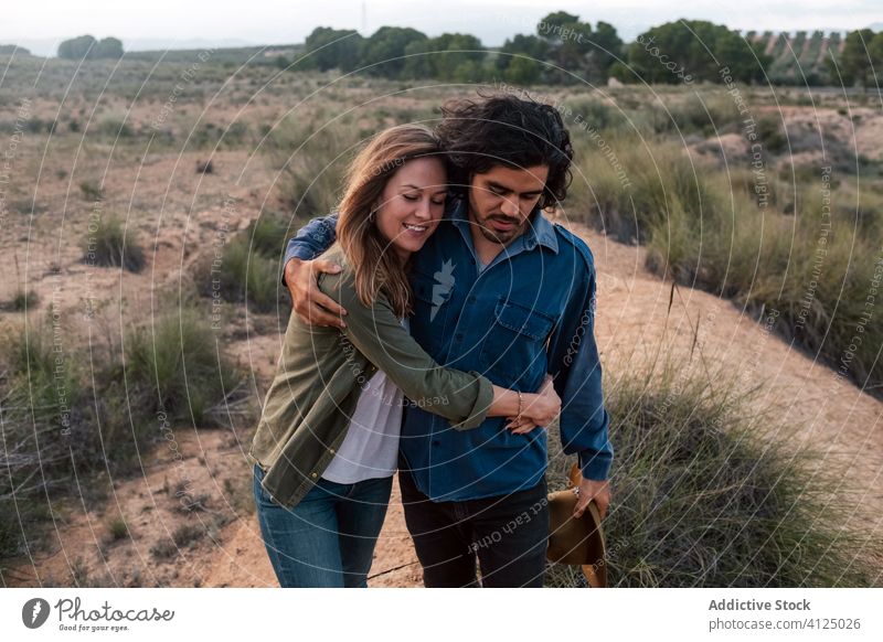 Happy couple walking in countryside evening date love bush happy tender sunset man woman cheerful romantic lifestyle smile leafless nature relationship together