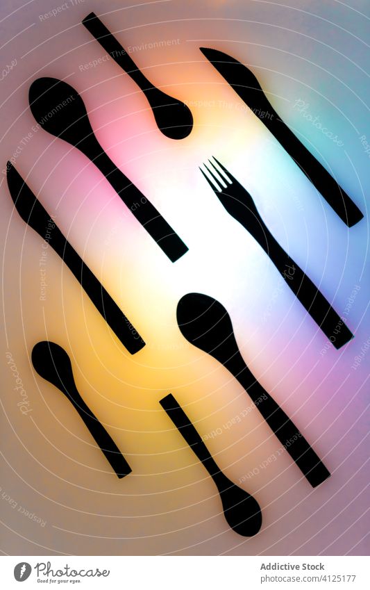 Set of cutlery on colorful background set composition spoon fork knife neon arrangement utensil tool tableware service object equipment black kitchen