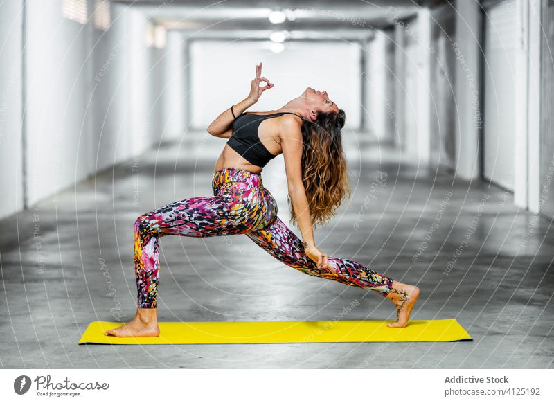 Experienced woman practicing advanced yoga asana - a Royalty Free