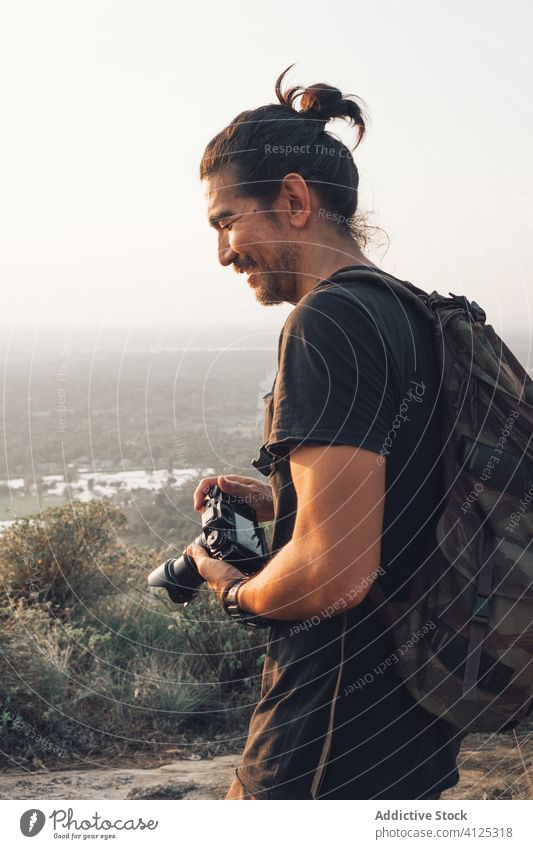 Traveling man taking picture of nature on cliff take photo smiling edge majestic landscape picturesque photographer traveler breathtaking forest camera freedom