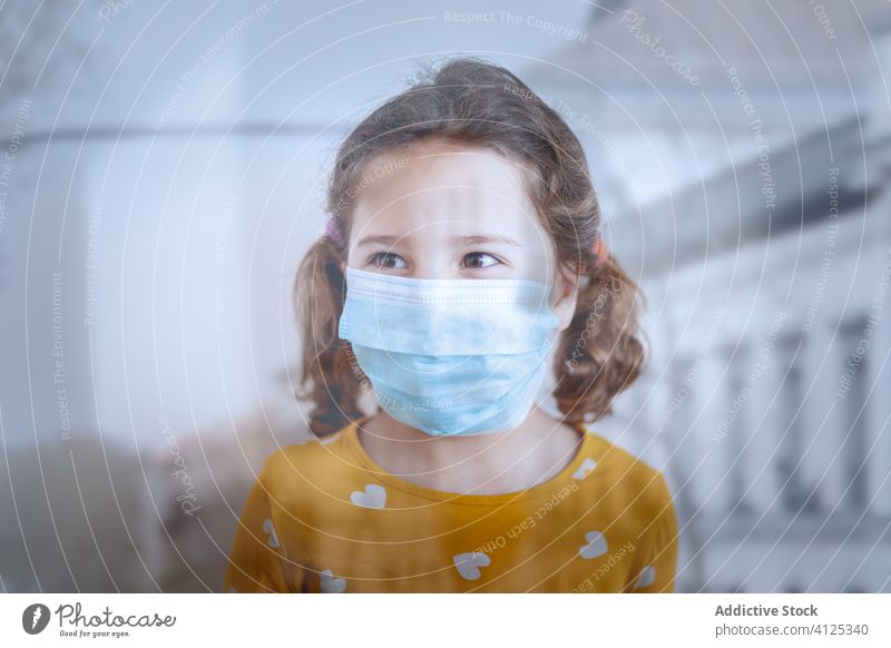 Little girl in medical mask standing in clinic hospital visit patient little healthy pandemic doctor epidemic protect kid coronavirus flu covid 19 cloth yellow