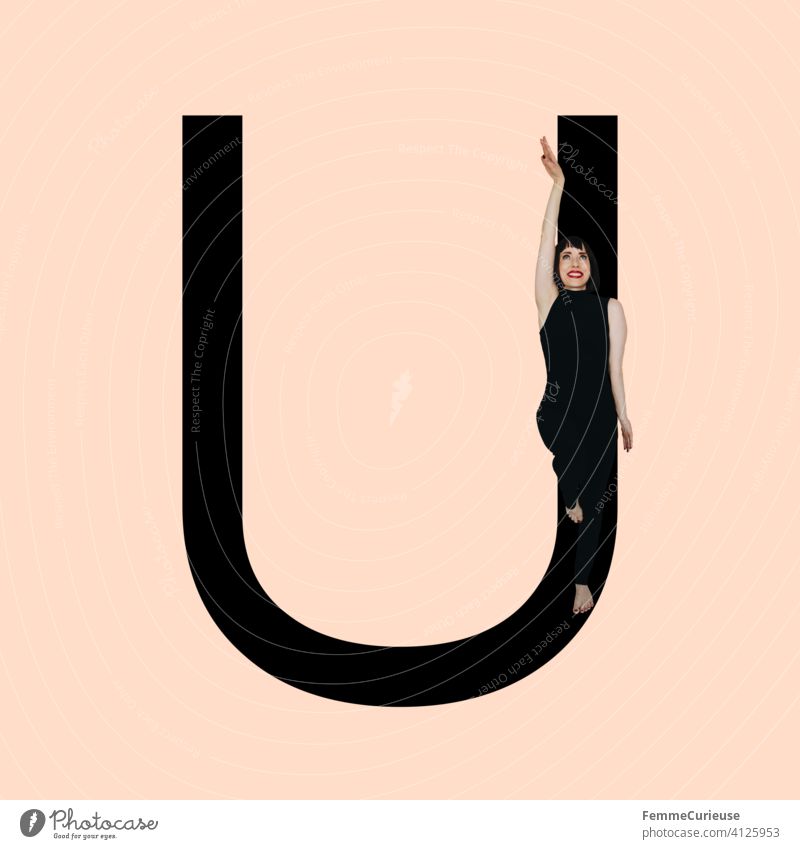 Graphic shows black letter U of the Latin alphabet against a skin-coloured background and integrated photographic full-body shot of a posing brunette woman with bob hairstyle in black one-piece suit