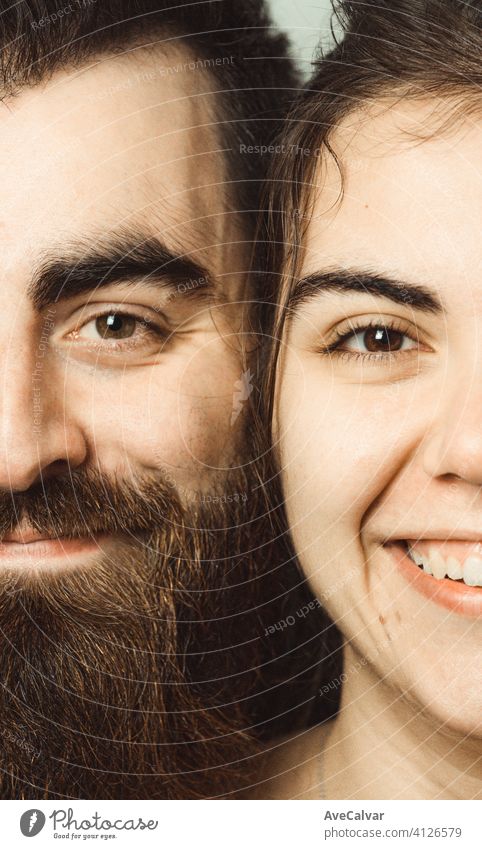 Super close up of a couple of a man and a woman smiling to camera , love concept person together male care caucasian close-up face female portrait young
