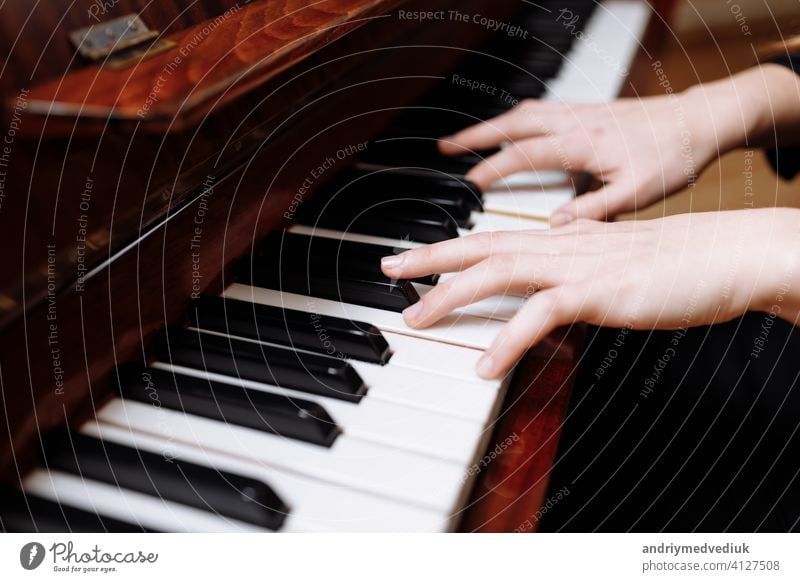 Close up of the hands of a young woman playing piano music key instrument female player keyboard musical close girl caucasian closeup style white human art