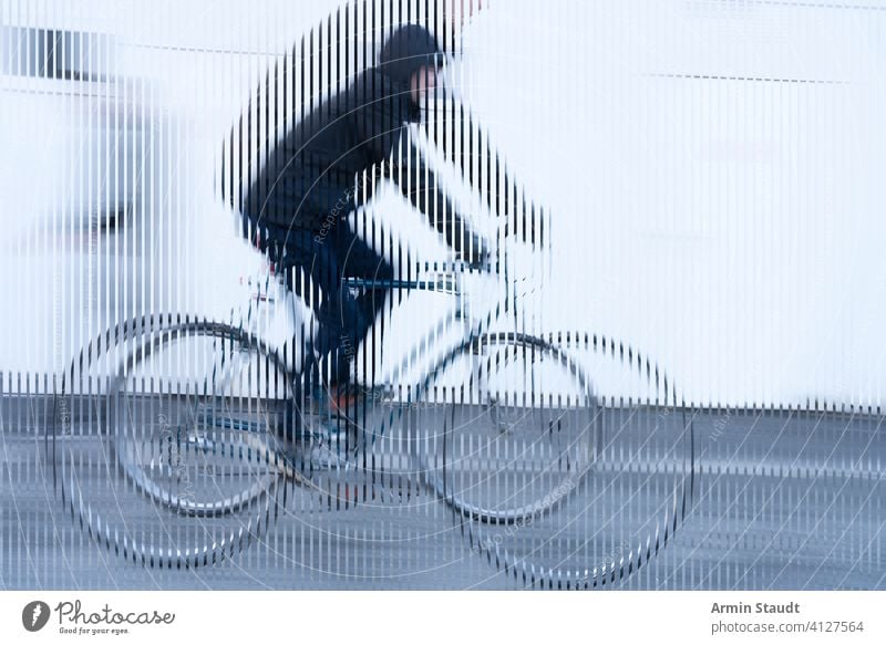 stripes image, movement of a cyclist with black jacket on white background bike bicycle look cropped speed double exposure outdoors wall street road tire sport