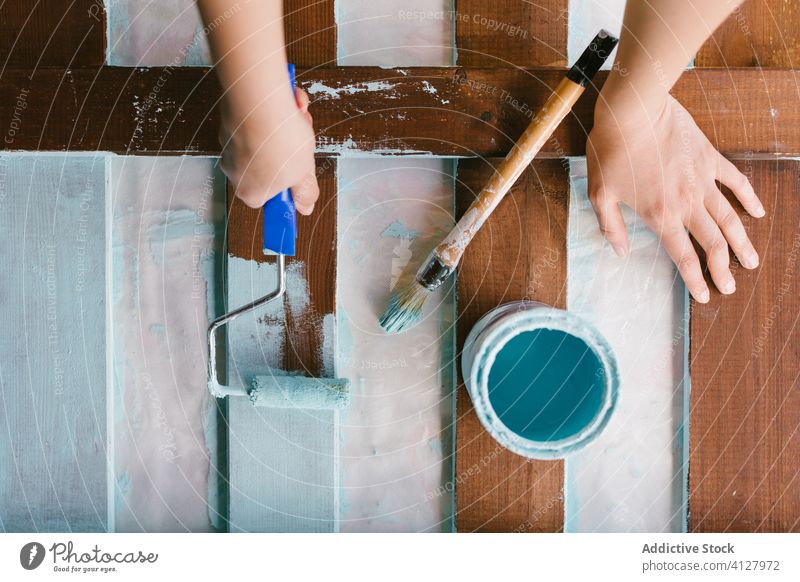 Hands painting an old fence skill craft equipment brush caucasian construction craftswoman diy do it yourself female blonde furniture handcraft handmade hobby