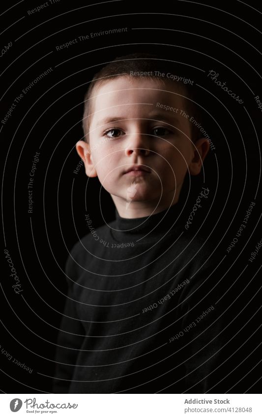 Pensive kid isolated on black pensive sad portrait boy thoughtful serious little child childhood person human face cute posing casual calm auto transport dream