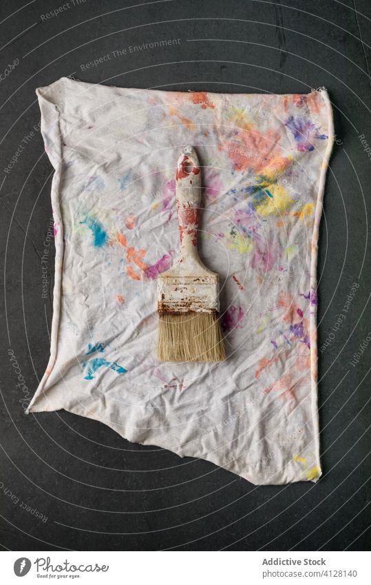 Paintbrushes on painted cloth paintbrush creative hobby messy scraper inspiration color artwork colorful imagination table wooden bright vivid vibrant