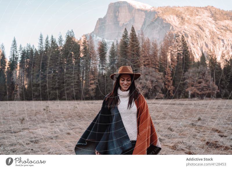 Happy woman enjoying sunny day in mountains travel happy relax forest yosemite park cliff edge rock stone national female style trendy landscape young boho