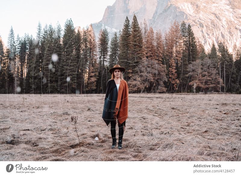 Happy woman enjoying sunny day in mountains travel happy relax forest yosemite park cliff edge rock stone national female style trendy landscape young