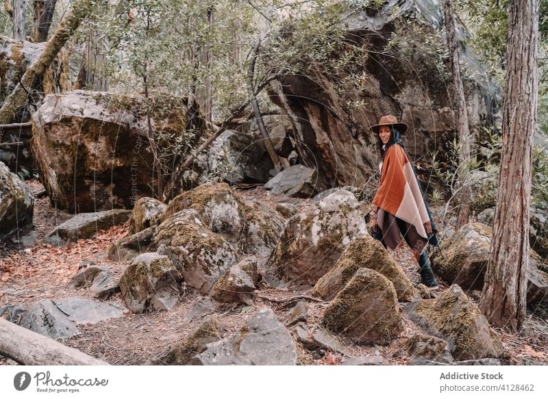 Young woman standing near large stones in forest rock boulder travel trendy style tree landscape yosemite park boho rustic united states mountain national