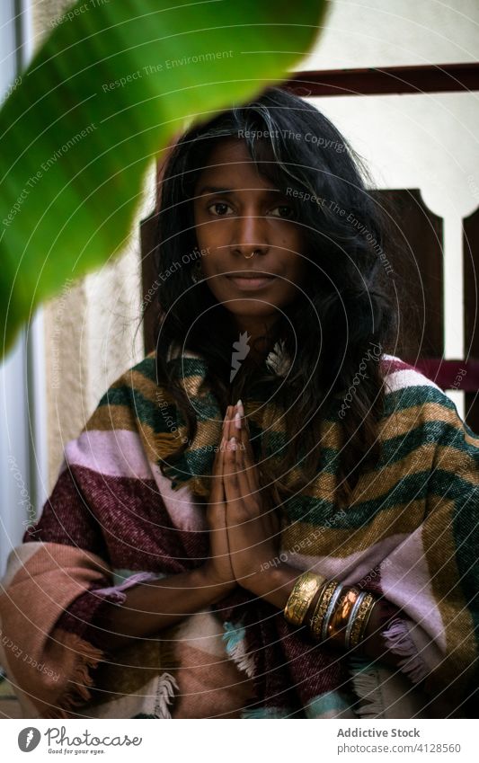 Ethnic holy woman with namaste gesture spirit ethnic ritual calm tranquil portrait positive shaman religion culture female tradition young worship belief exotic
