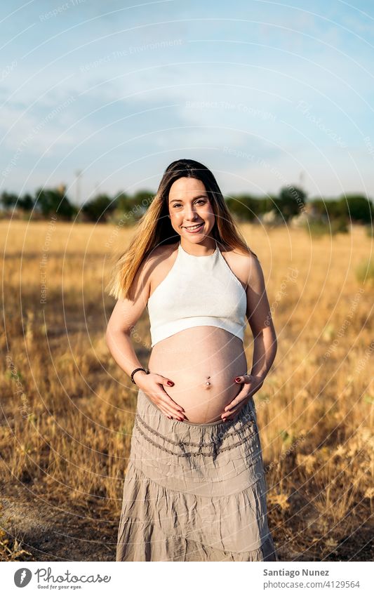 Pregnant Woman Portrait woman happy beautiful young pregnant pregnancy pregnant woman smile smiling portrait lovely waiting stomach touching hand female adult