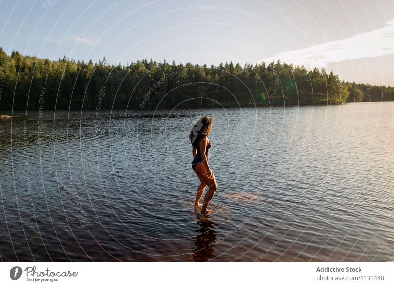 Woman in swimsuit standing in lake woman water calm sunset enjoy summer majestic scenery female forest landscape tranquil serene harmony peaceful idyllic wood