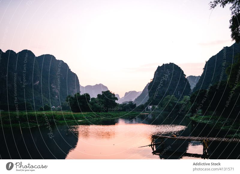 Magnificent scenery of lake during sunset mountain pier sundown magnificent ripple majestic rock vietnam asia landscape wooden quay peaceful harmony tranquil