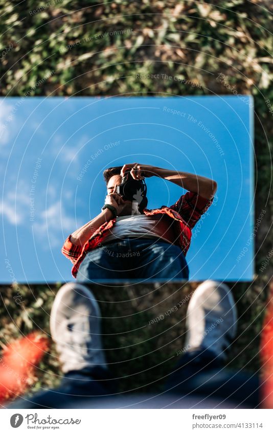 Young photographer taking a selfie young man mirror portrait self portrait background abstract sky grass mockup copy space rectangle clouds nature light natural