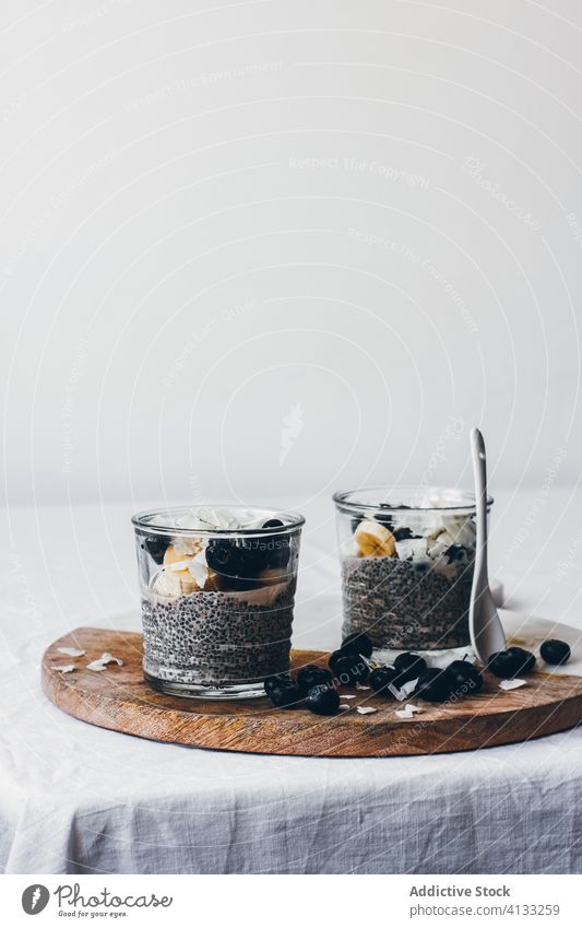 Yummy chia pudding on wooden board with banana and berries milk delicious honey berry glass healthy dessert almond tasty fresh jar sweet organic dairy