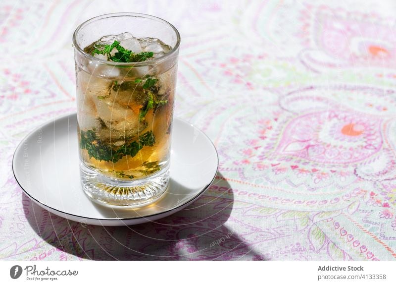 Iced tea with lemon and mint in glasses on table cold ice drink cafe refreshment citrus beverage cool fruit slice liquid cube delicious tasty healthy ingredient