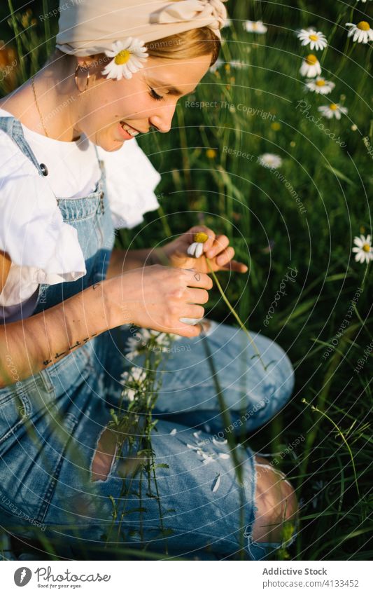 Calm female resting on green meadow in spring woman chamomile field rural pick collect smell calm enjoy bouquet fresh flower nature young bloom blossom relax
