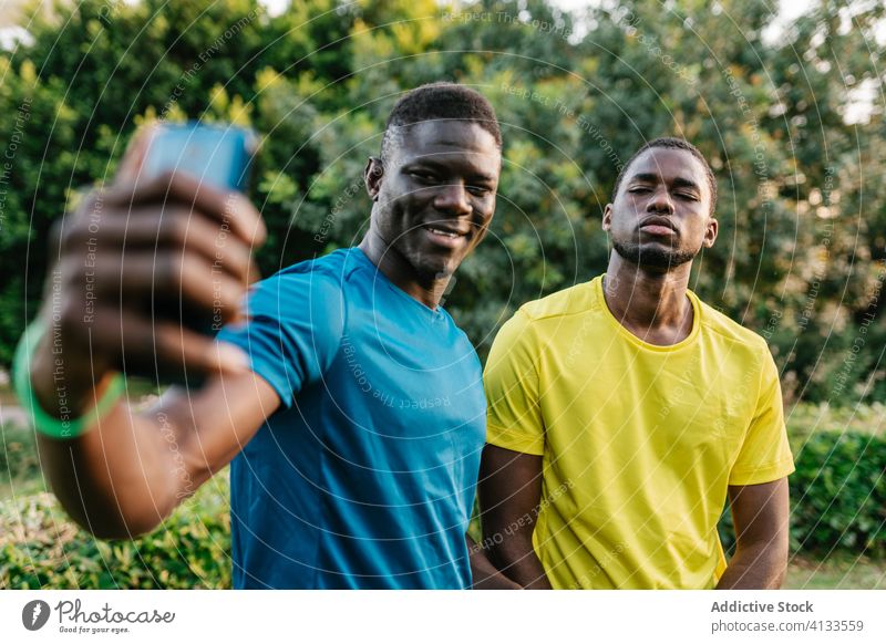 Two black men taking selfie phone happy park male outdoors mobile smiling african people young happiness cheerful adult friends portrait youth smartphone