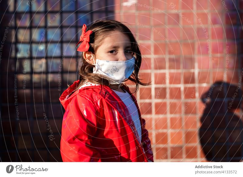 Ethnic girl in surgical mask on street medical child enjoy weekend covid 19 protect ethnic childhood kid city stand safety care healthy health care coronavirus